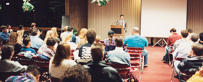 Jim Plaxco addressing an audience, Harper College, Palatine IL